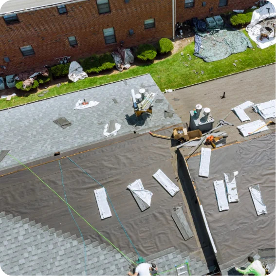 Overhead view of an apartment building during a roofing job.