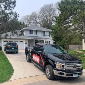 Home with new roof and insulation. Midwest Roofing, Siding & Windows truck in the driveway.